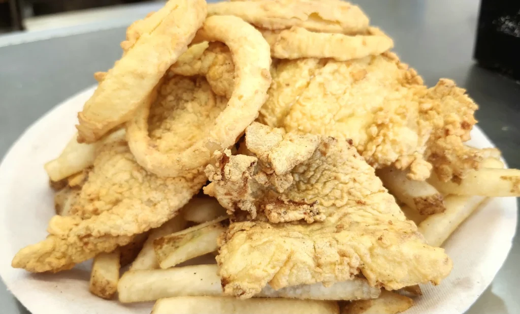 Fried haddock plate with onion rings and fries